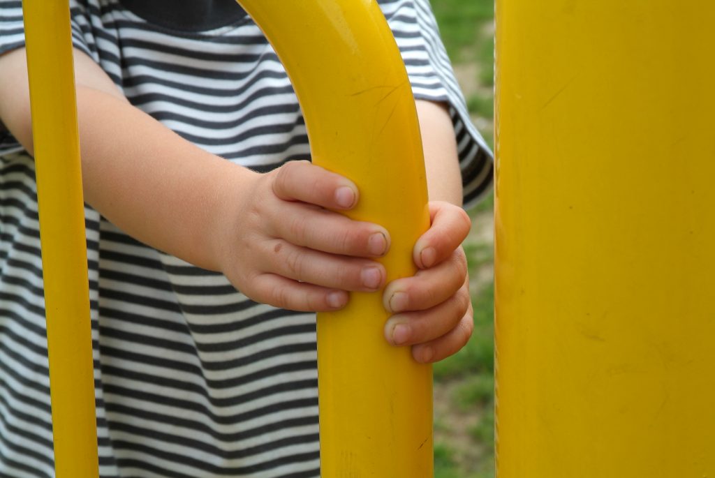 a child holding on to the mono hinge gate